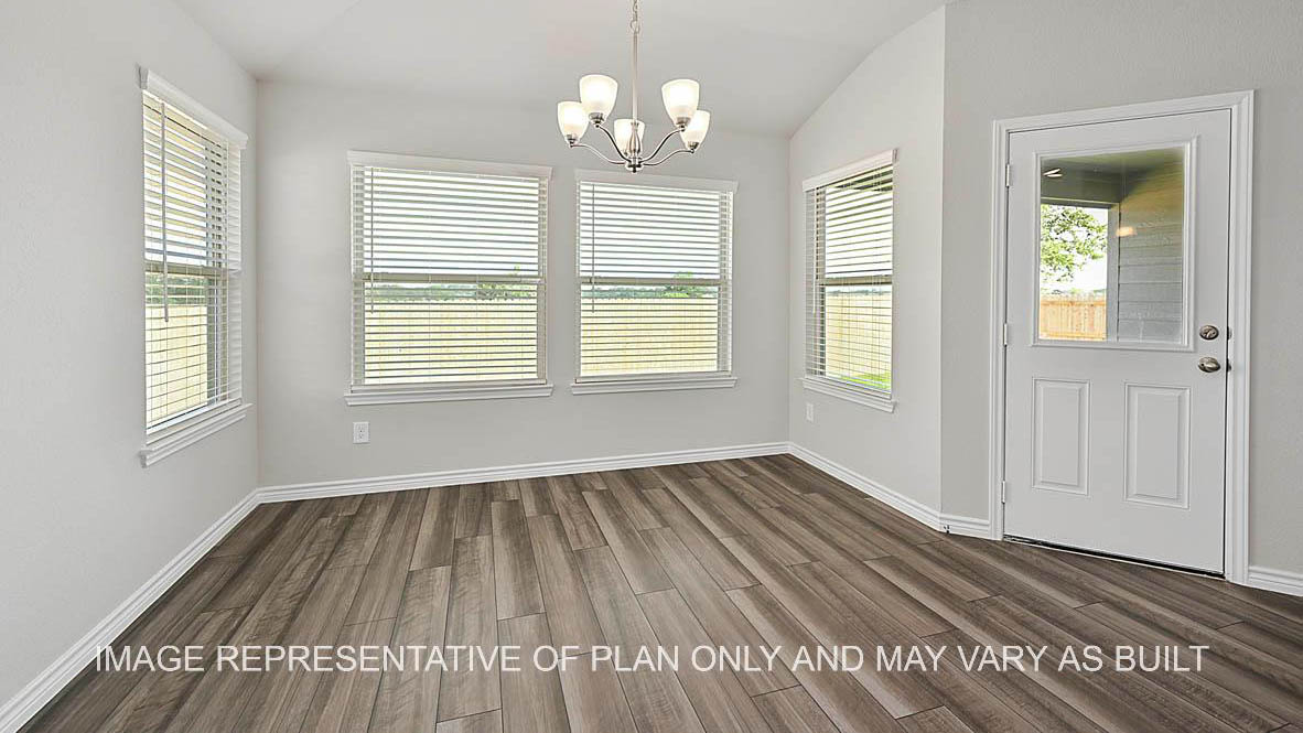 Prescott dining room with large windows with view to backyard and vinyl plank flooring.