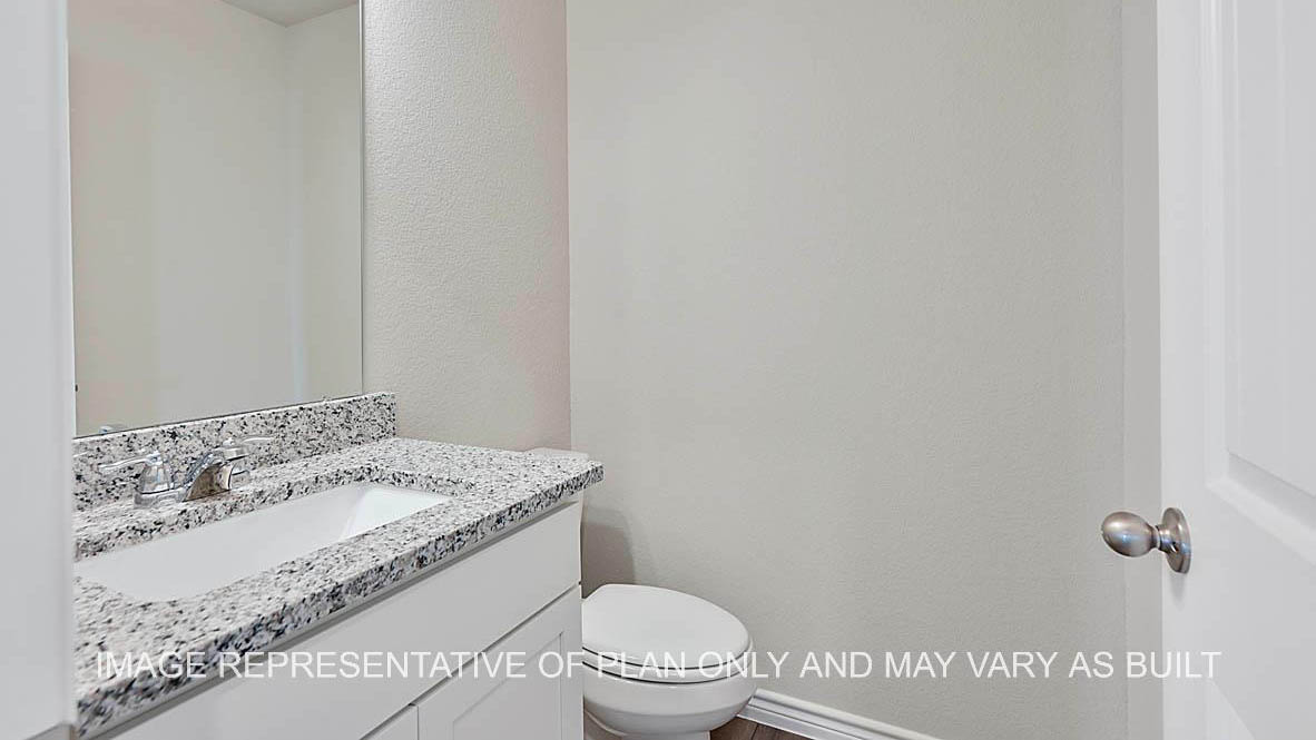 Prescott secondary bathroom with white cabinets, granite countertops, ceramic tile shower surround and vinyl plank flooring.