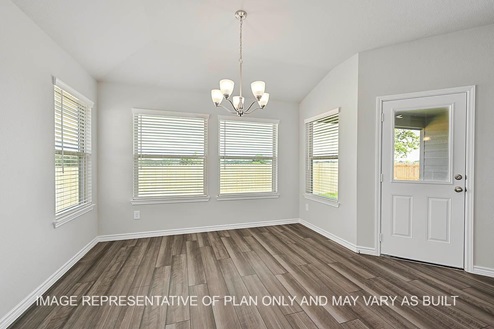 Prescott dining room with large windows with view to backyard and vinyl plank flooring.