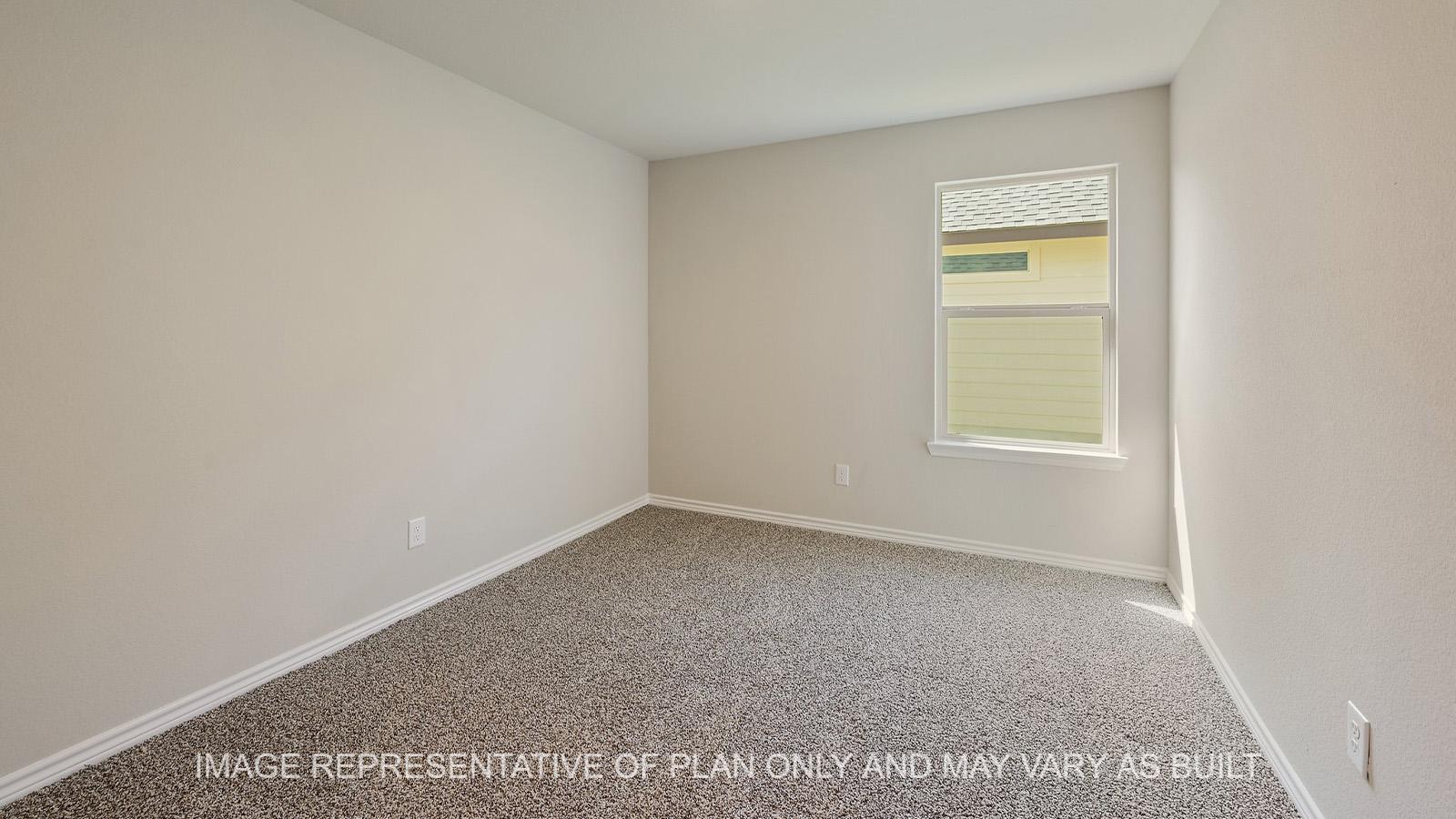 Everett secondary bedroom with window and carpeted flooring.