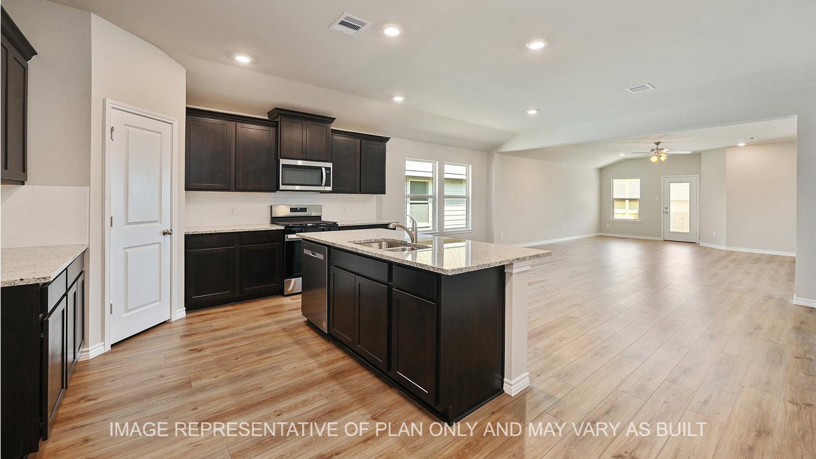 Everett open-concept kitchen with dark cabinetry, granite countertops, tile backsplash, and vinyl plank flooring.