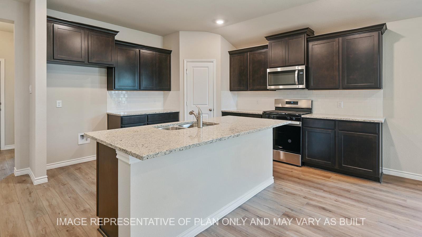 Everett open-concept kitchen with dark cabinetry, granite countertops, tile backsplash, and vinyl plank flooring.