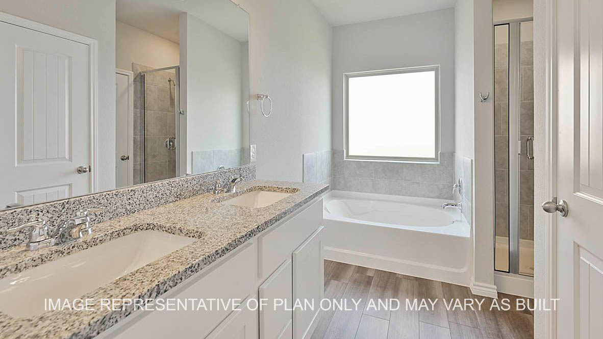 Sonoma primary bathroom with white cabinets, granite countertops, ceramic tile shower surround and vinyl plank flooring.