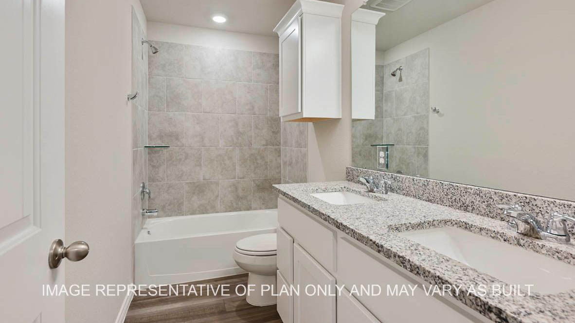 Sonoma secondary bathroom with white cabinets, granite countertops, ceramic tile shower surround and vinyl plank flooring.