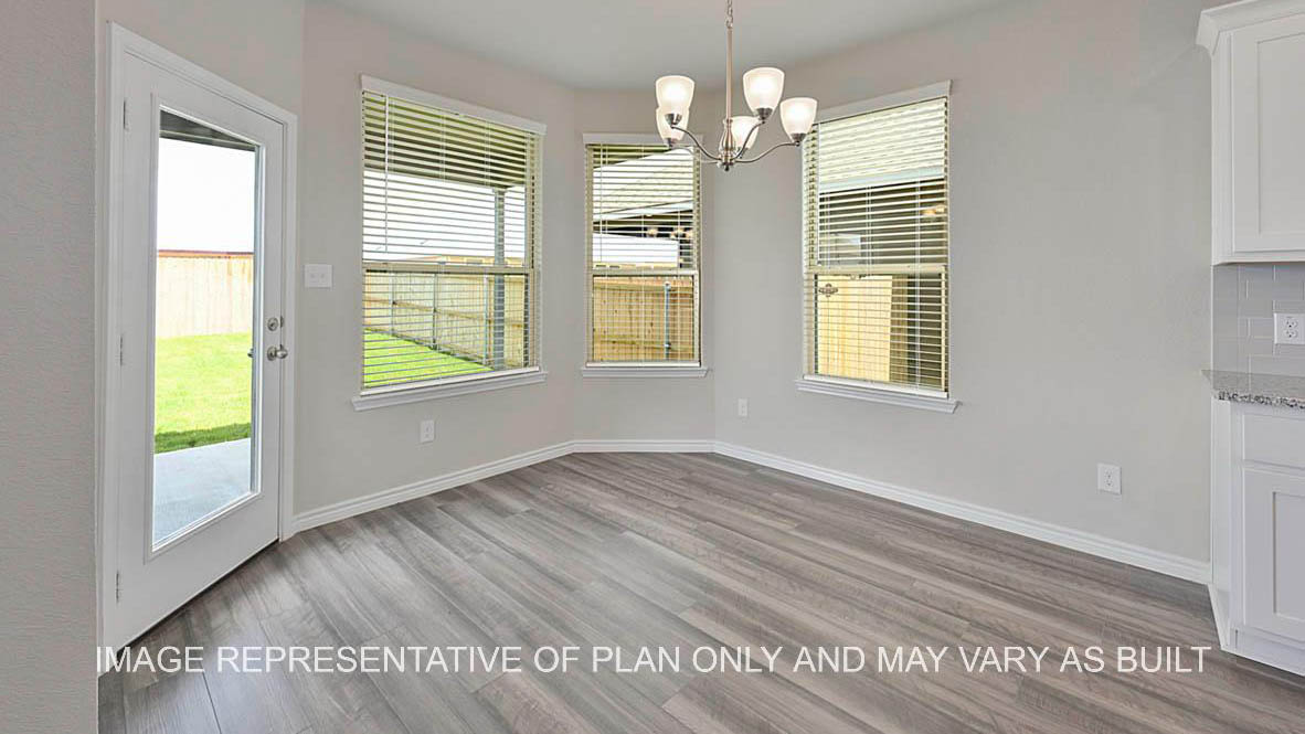 Sonoma dining room with bay windows and vinyl plank flooring.