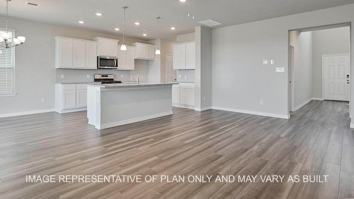 Sonoma living room with vinyl plank flooring, open to the kitchen.