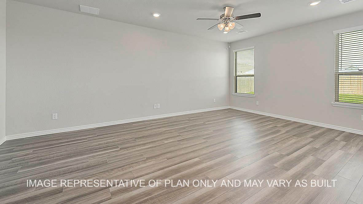 Sonoma living room with large windows and vinyl plank flooring.