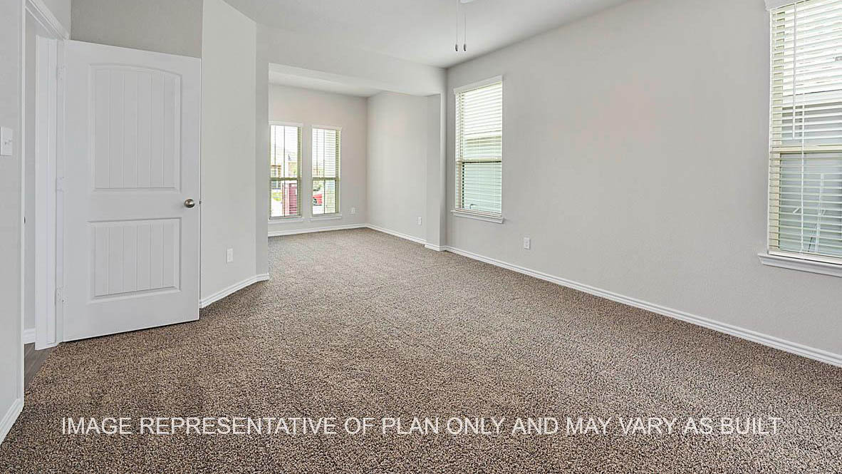 Sonoma primary bedroom with windows and carpet flooring.