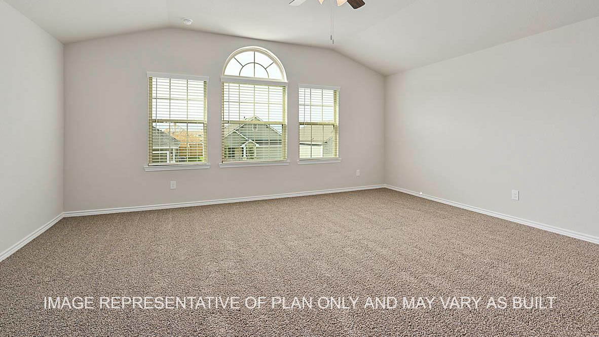 Kiawa primary bedroom with windows and carpeted flooring.