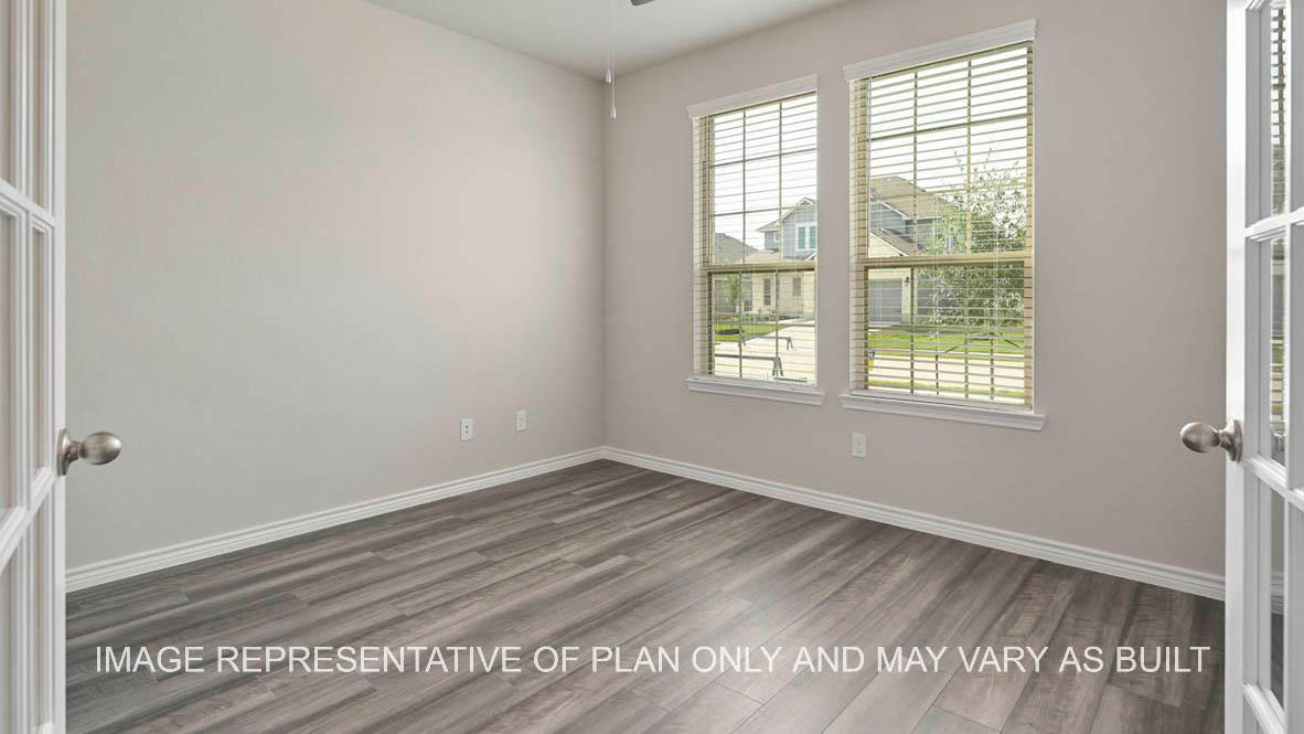 Kiawa study with front facing windows, laminate flooring, and french doors.