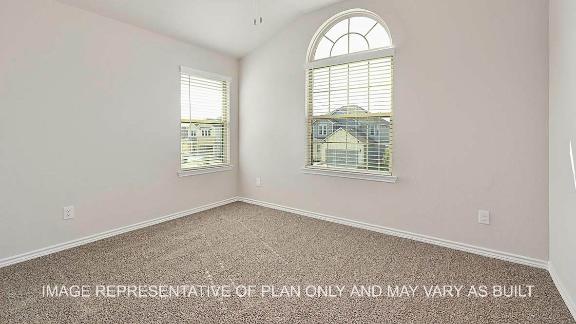 Kiawa secondary bedroom with windows and carpeted flooring.