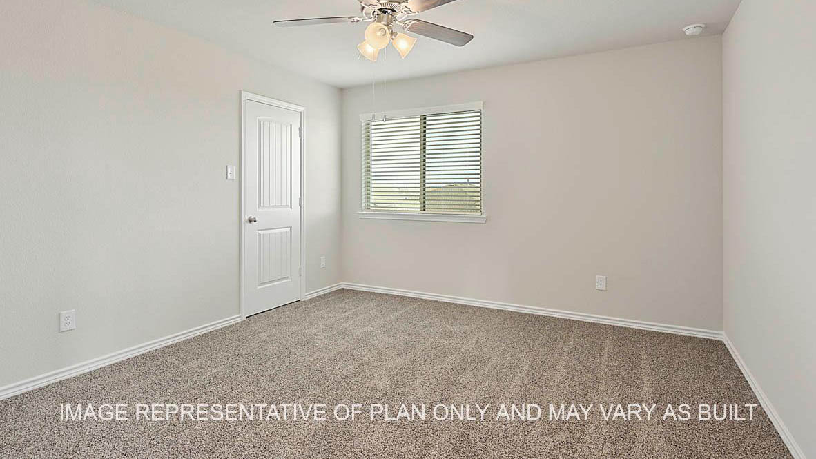 Kiawa secondary bedroom with window, carpeted flooring, and view to closet.