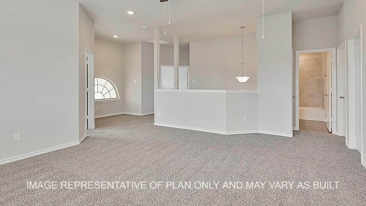 Kiawa gameroom with view to stairs and bathroom and carpeted flooring.