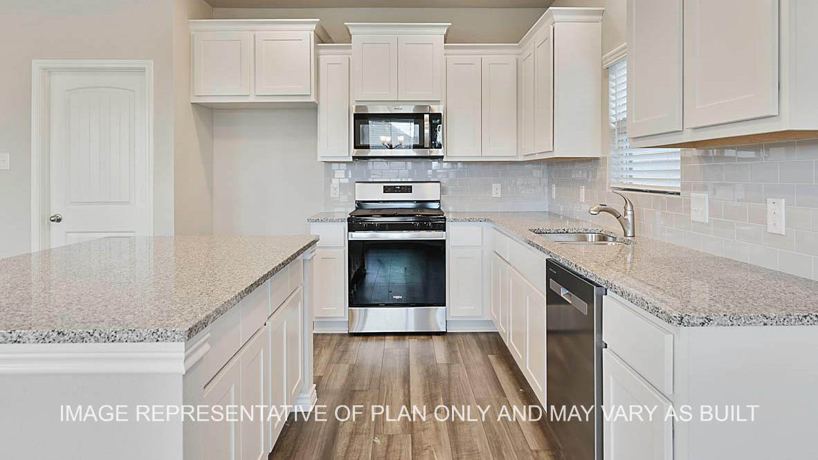 Kiawa kitchen with white cabinetry, granite countertops, tile backsplash, laminate flooring and kitchen island.