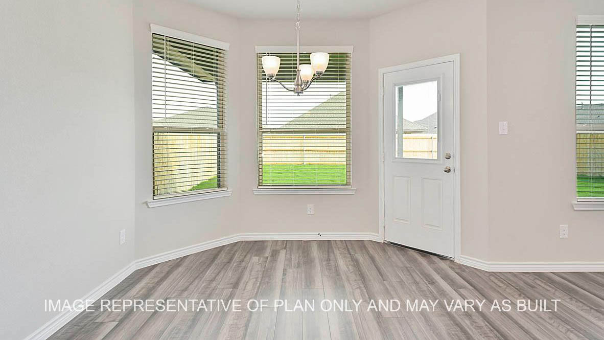 Kiawa dining nook with windows, laminate flooring, and view to back door.