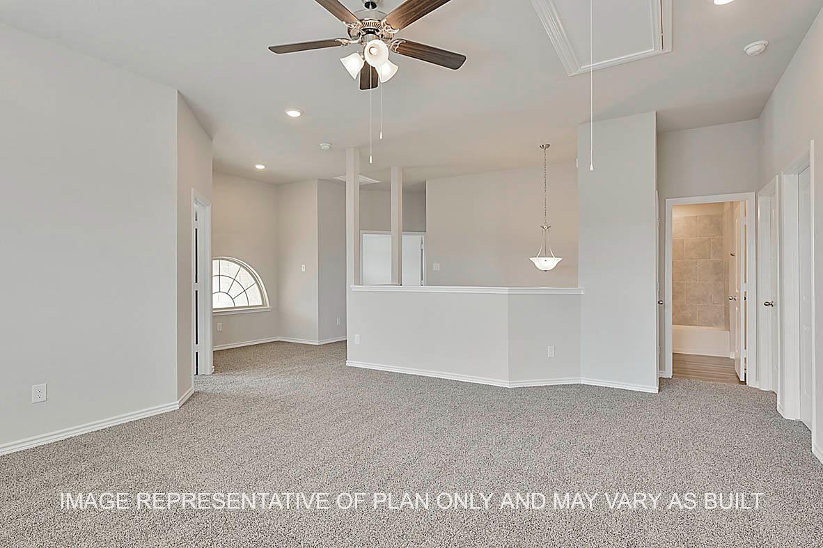 Kiawa gameroom with view to stairs and bathroom and carpeted flooring.