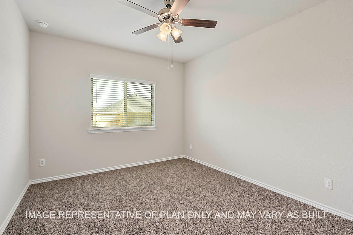 Kiawa secondary bedroom with window and carpeted flooring.