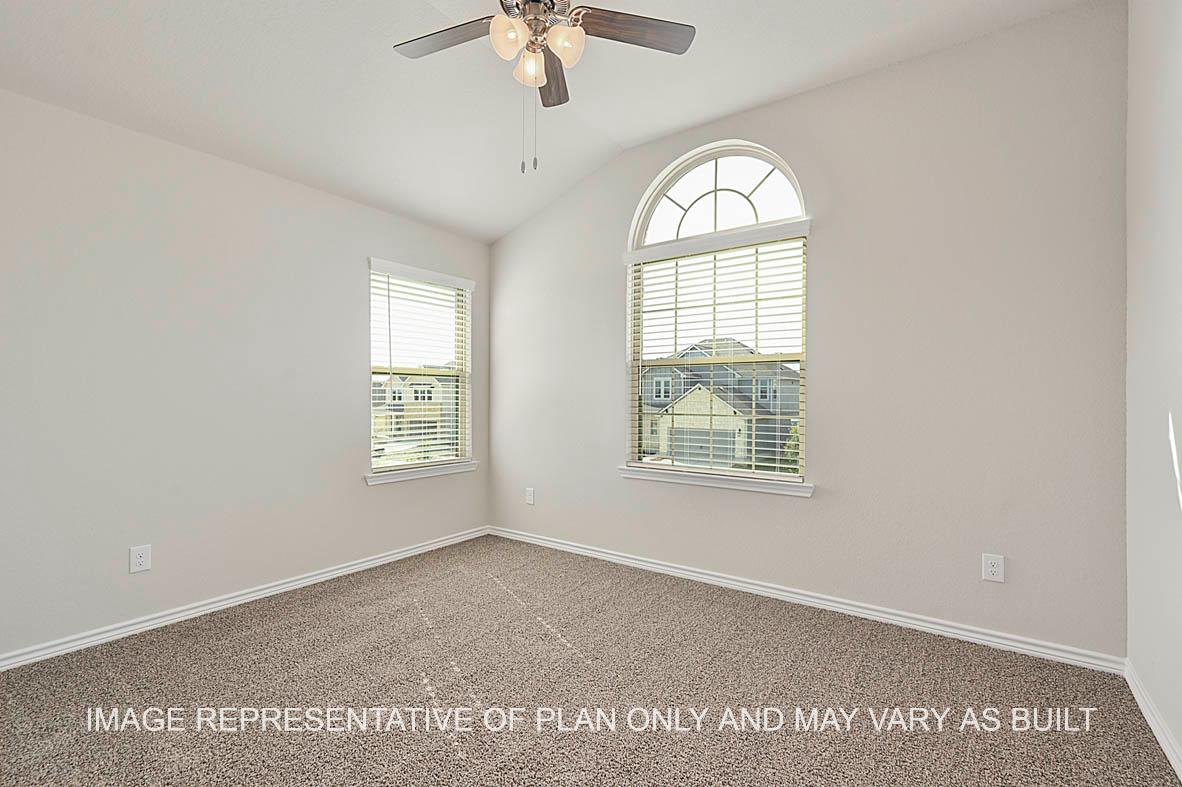 Kiawa secondary bedroom with windows and carpeted flooring.