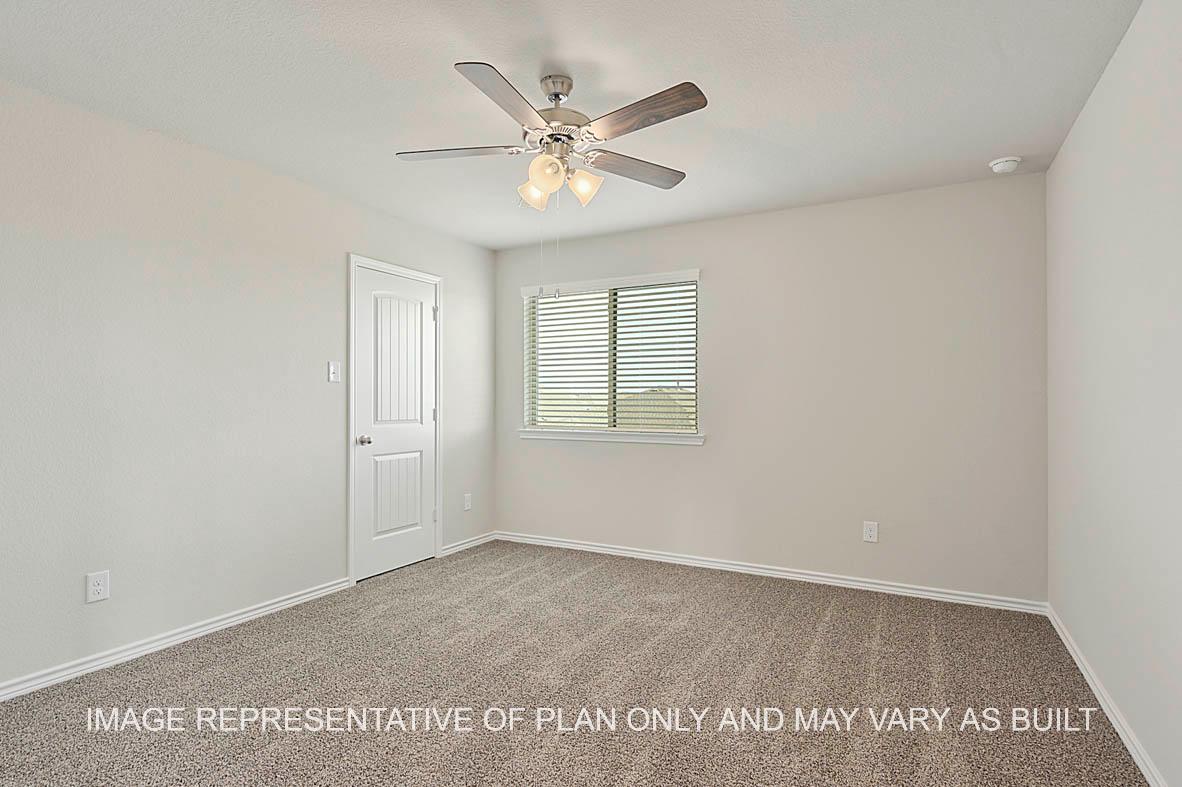 Kiawa secondary bedroom with window, carpeted flooring, and view to closet.