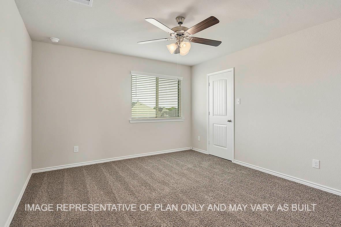 Kiawa secondary bedroom with window, carpeted flooring, and view to closet.