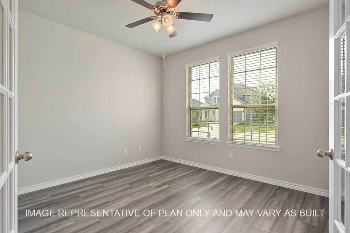 Kiawa study with front facing windows, vinyl plank flooring, and french doors.