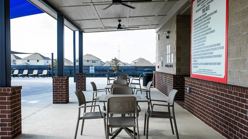 Southern Pointe club house patio with tables and chairs
