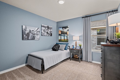Southern Pointe model home furnished secondary bedroom with window and carpeted flooring
