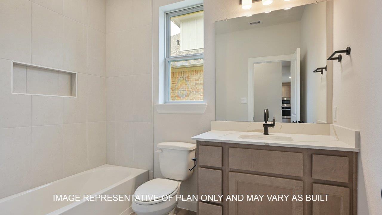 Brighton secondary bathroom with light stained cabinets, white quartz countertops and matte black fixtures.