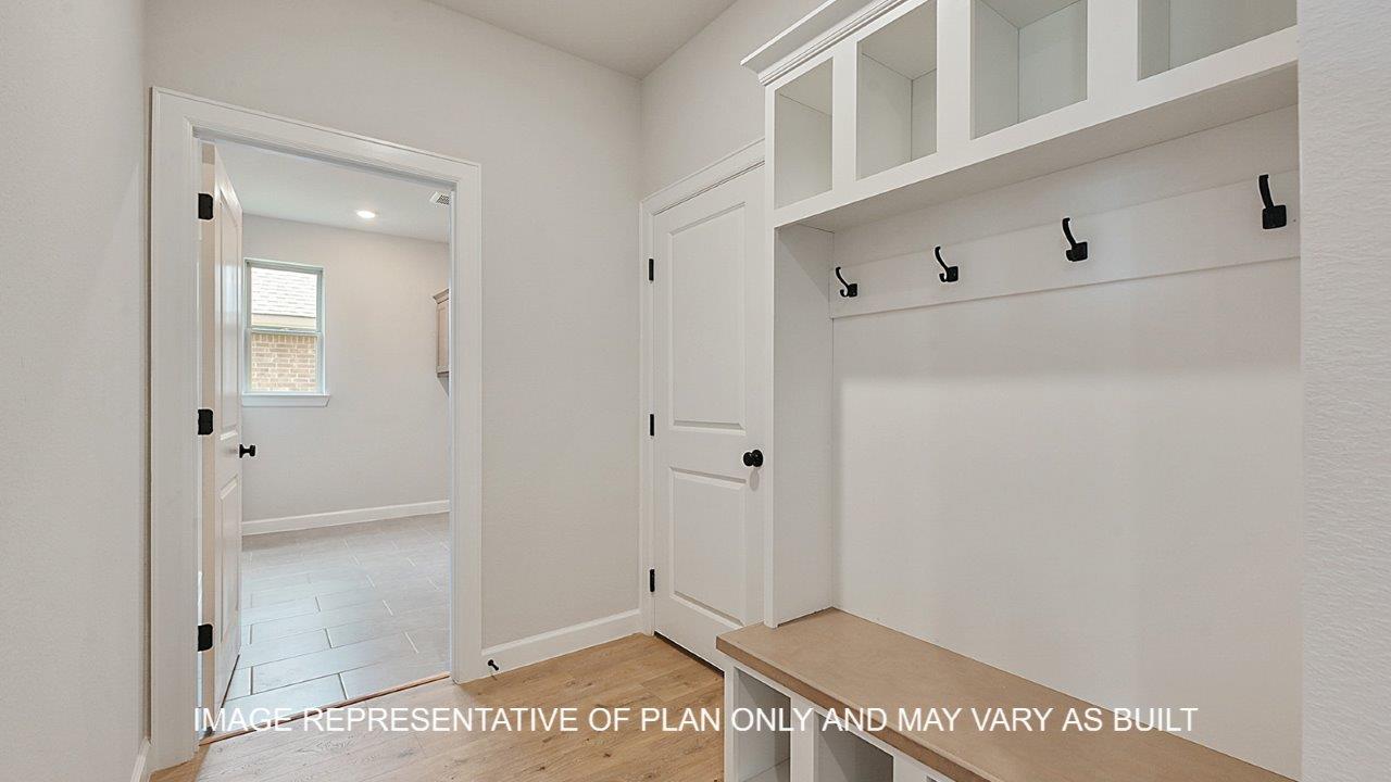 Brighton mud room with laminate wood flooring, bench with shelves and hooks.