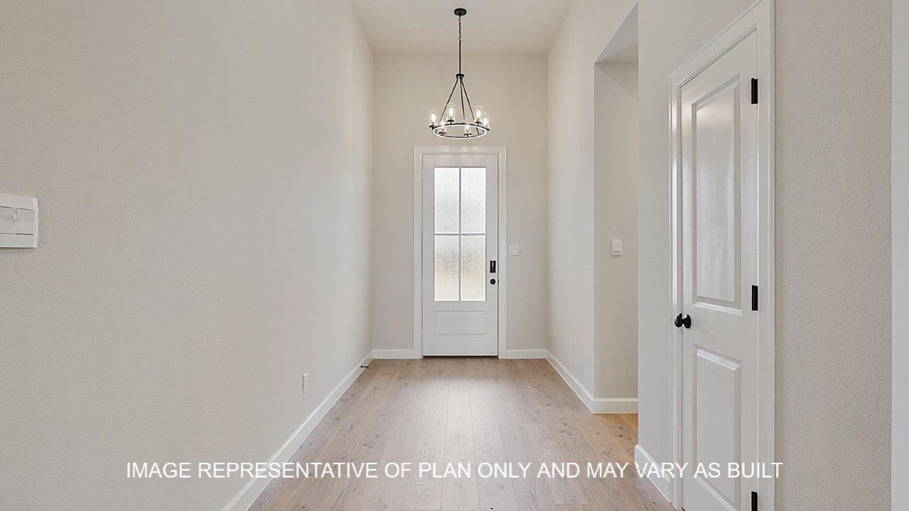 Brighton entry with laminate flooring and view of front door.