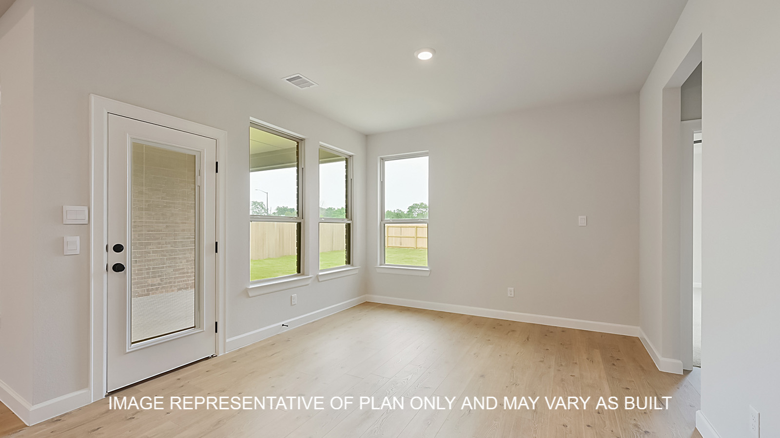 Brighton dining room with laminate wood flooring and view of backyard.