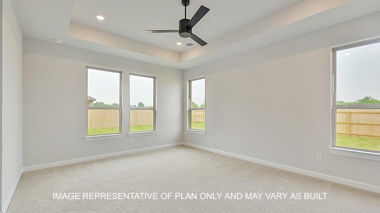 Brighton primary bedroom with carpet, windows and matte black ceiling fan.