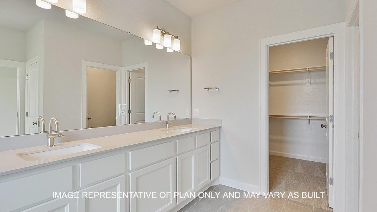 Oxford primary bathroom with tile flooring, separate tub and shower, white cabinets and white quartz countertops.