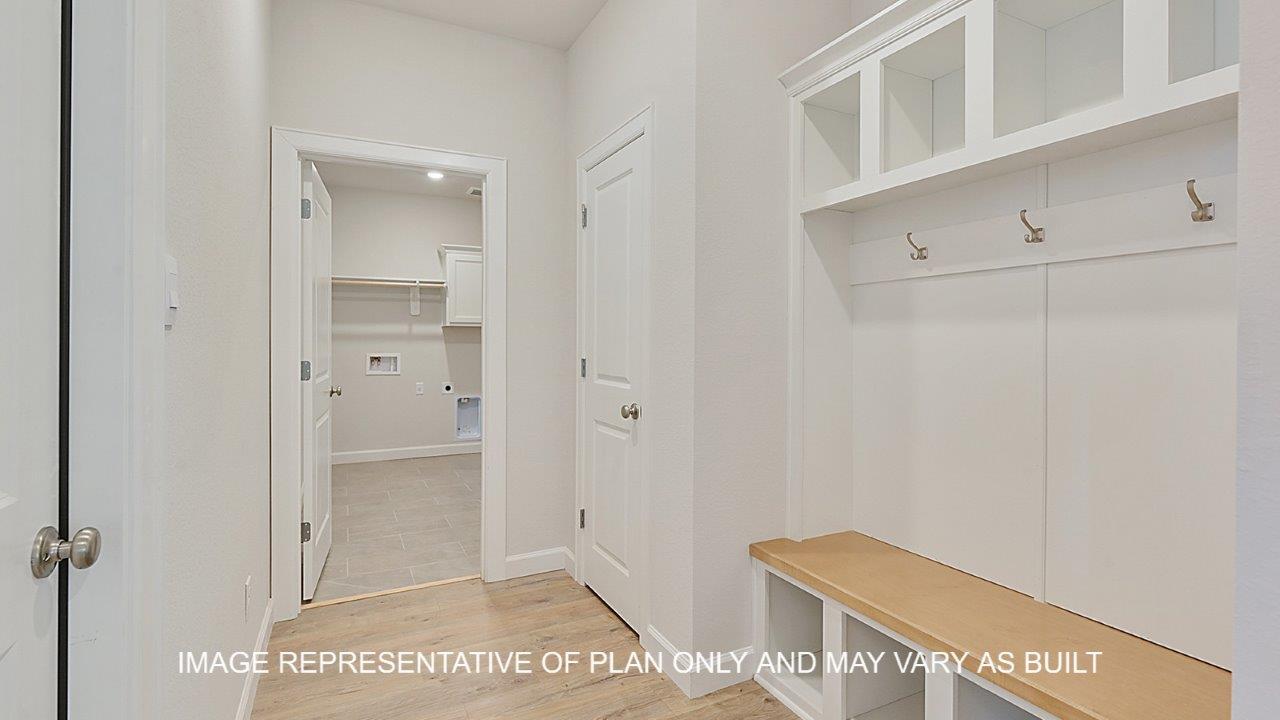 Oxford mud room with laminate wood flooring, bench with shelves and hooks.