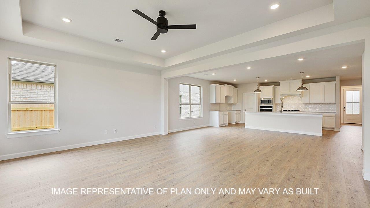 Oxford living room with laminate wood flooring and view of open concept kitchen.