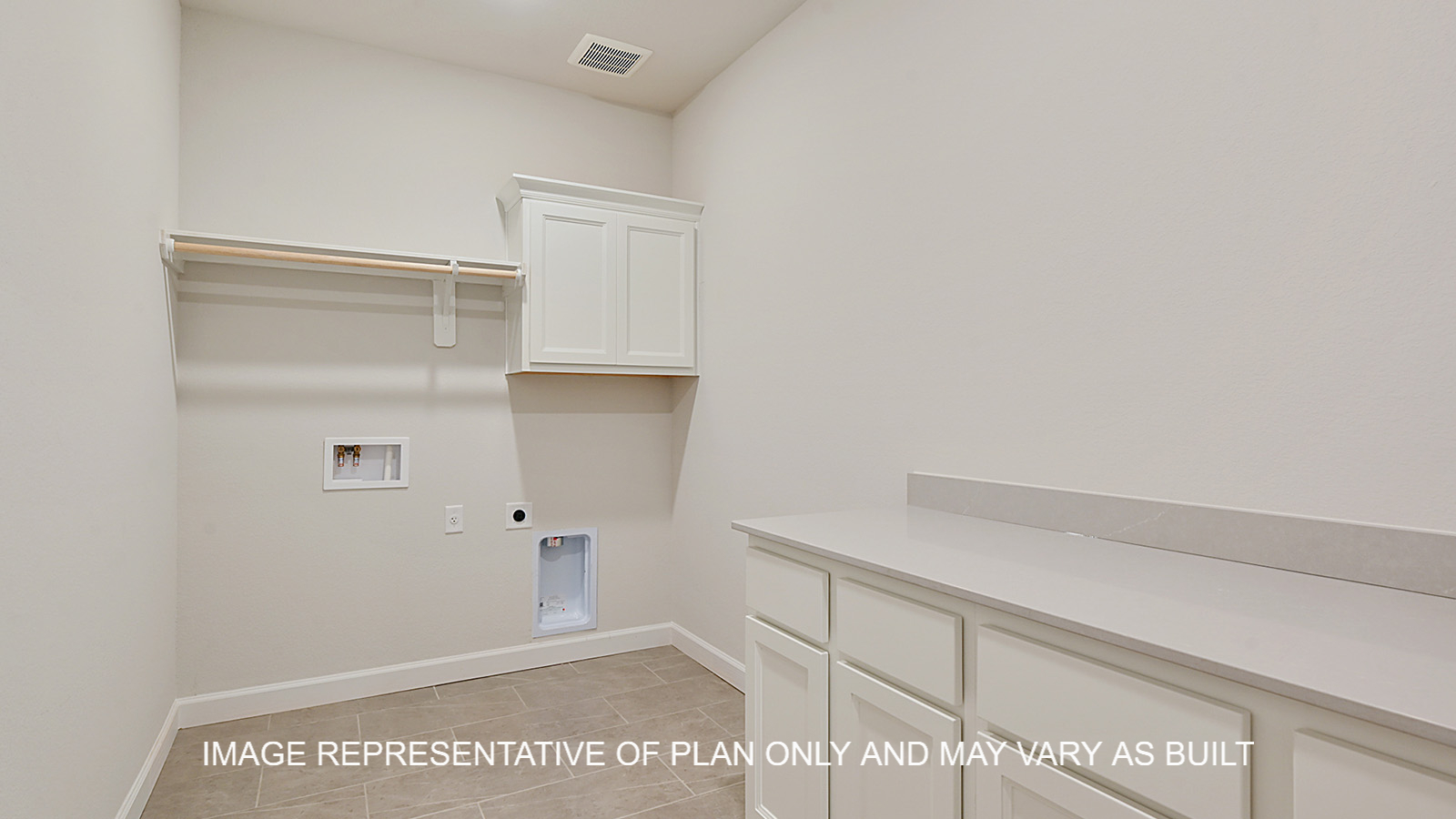 Oxford utility room with white cabinets, white quartz countertop with hanging rack for clothing.