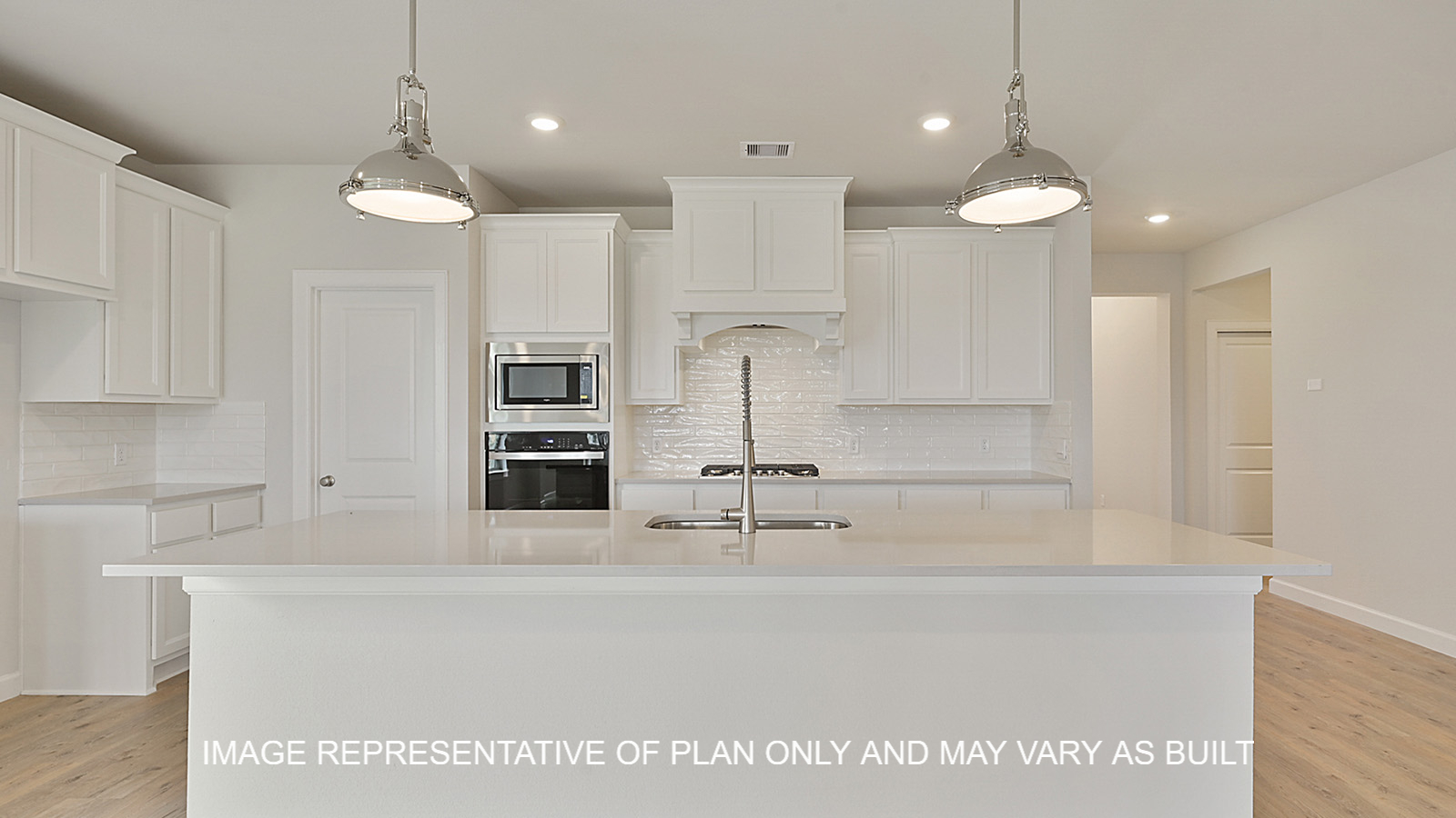 Oxford kitchen with white cabinets, white backsplash, quartz countertops and laminate wood flooring.