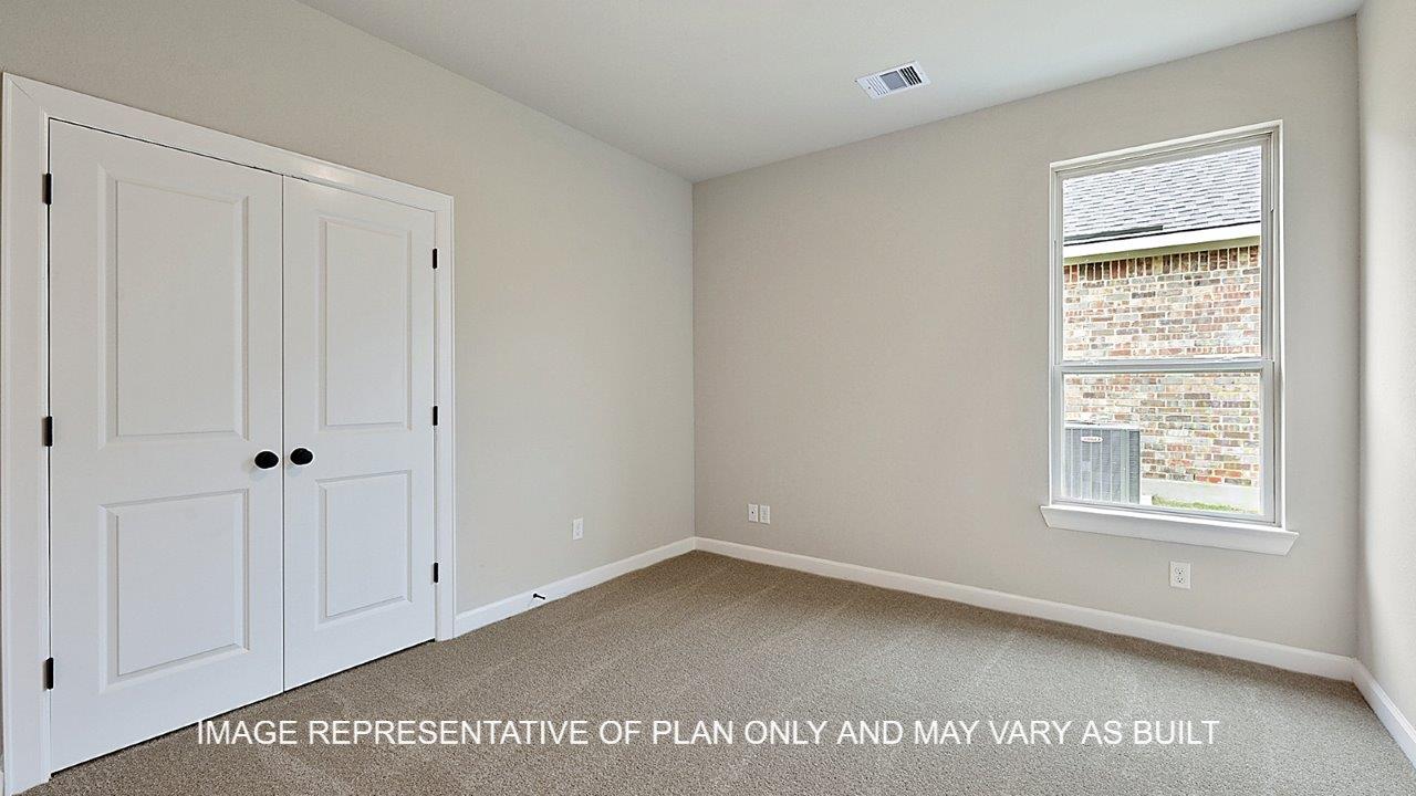 Stratford secondary bedroom with carpet and windows.