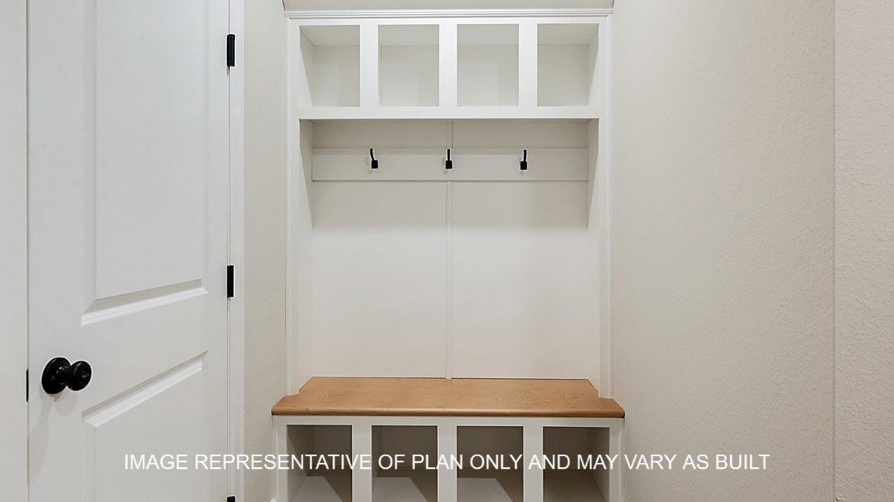 Stratford mud room with laminate wood flooring, bench with shelves and hooks.