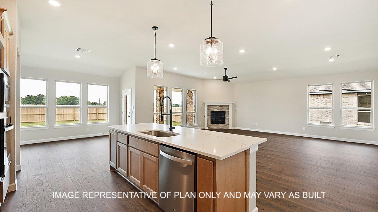 Stratford kitchen with view of living room with dark laminate wood flooring and corner fireplace.