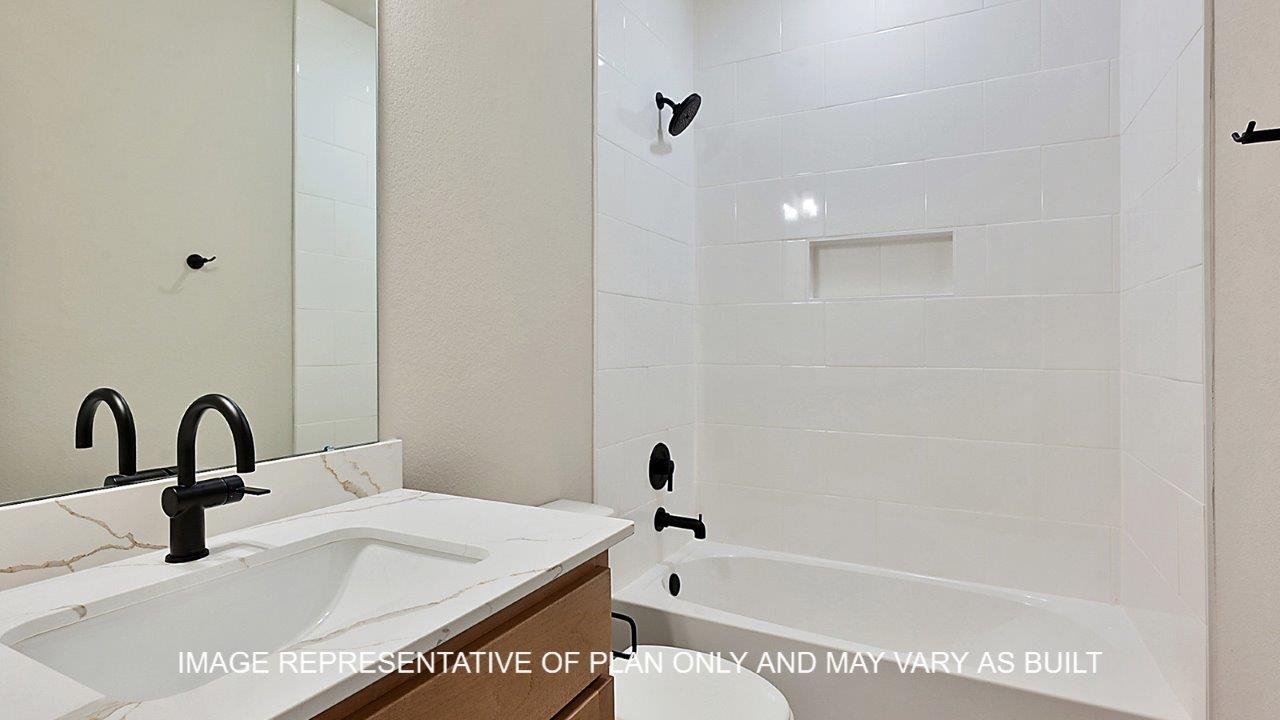 Stratford secondary bedroom with carpet and windows.