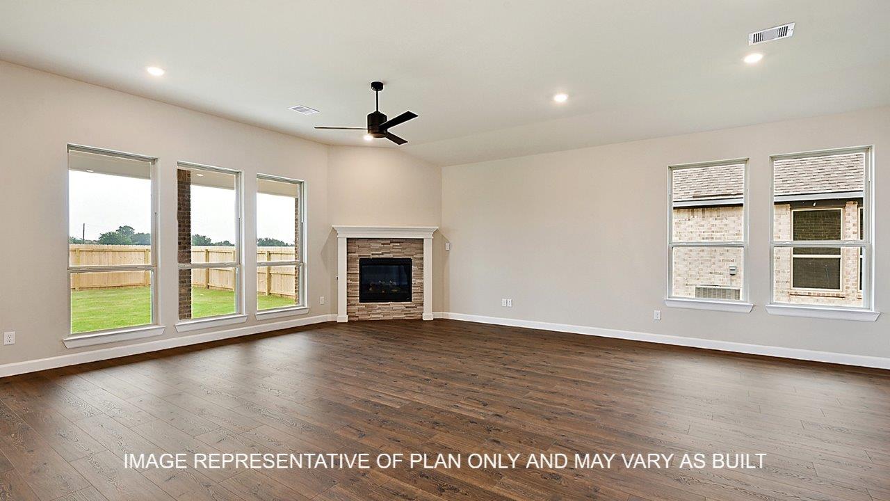 Stratford living room with corner fireplace and view into backyard.