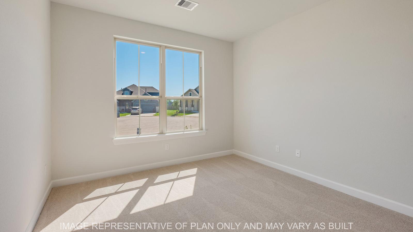 Weston secondary bedroom with carpeted flooring and window.