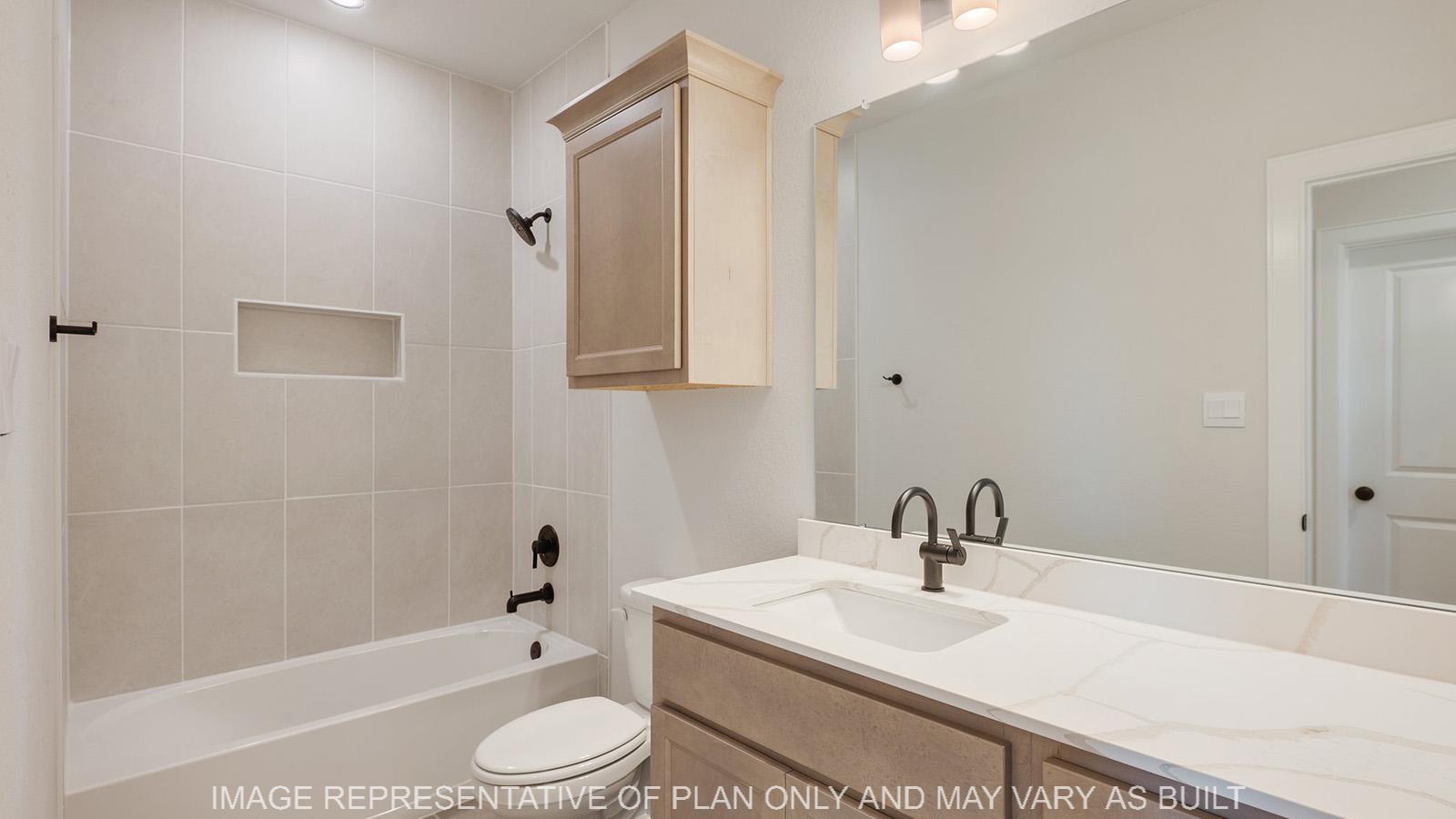 Weston secondary bathroom with maple cabinetry, white marble quartz vanity, ceramic tile shower/tub surround.