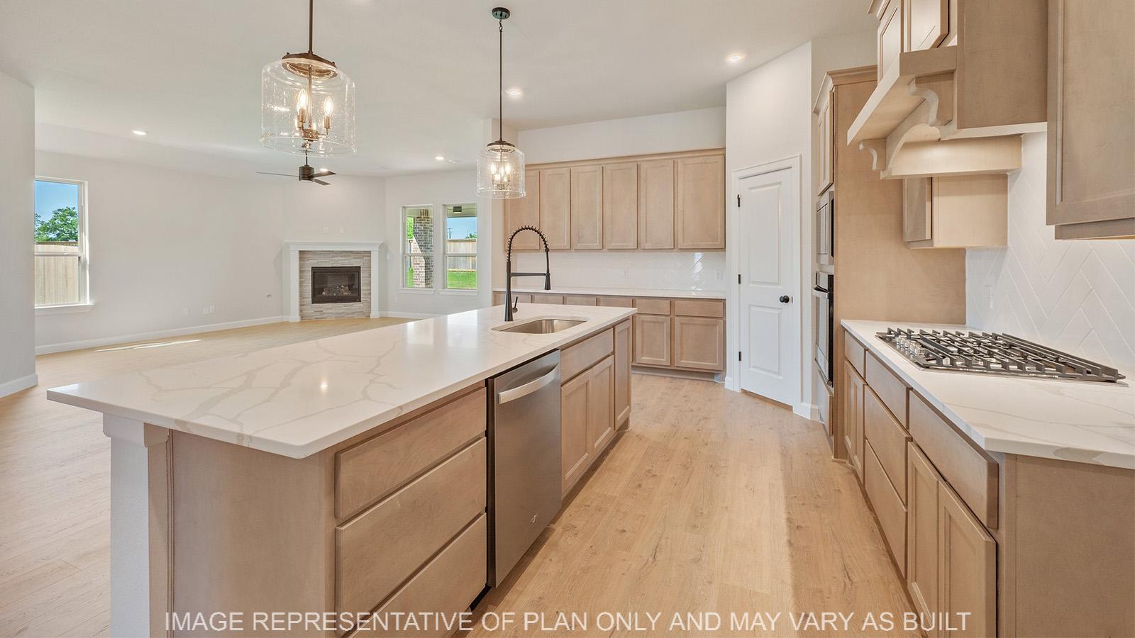 Weston kitchen with wood laminate flooring, oversized kitchen island, and view to living.