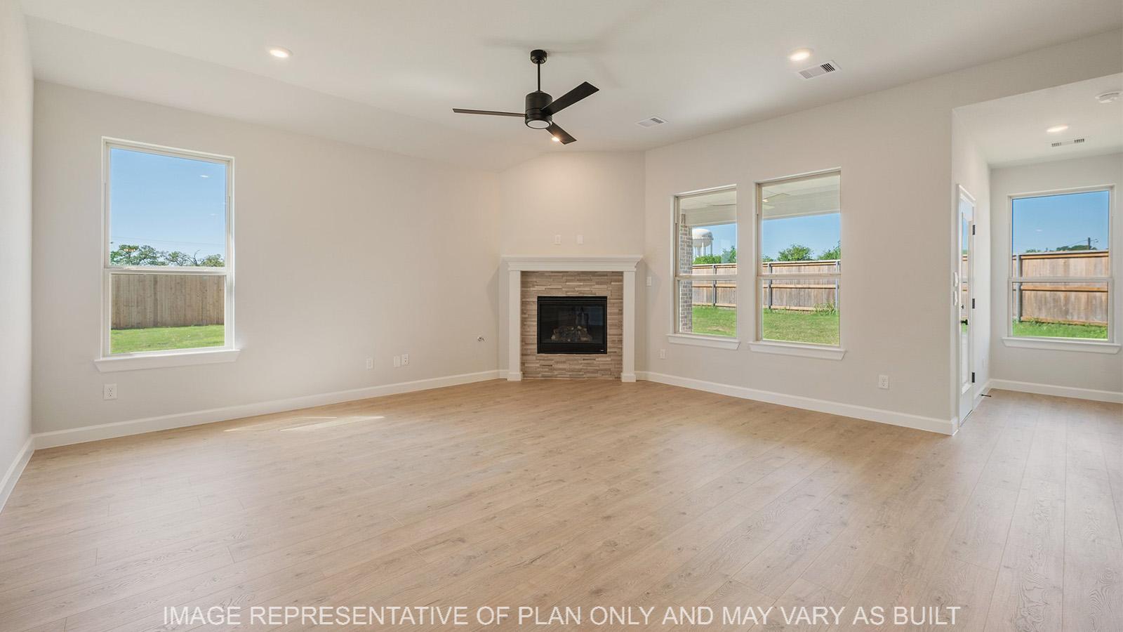 Weston living room with laminate flooring, corner fireplace, and natural lighting.
