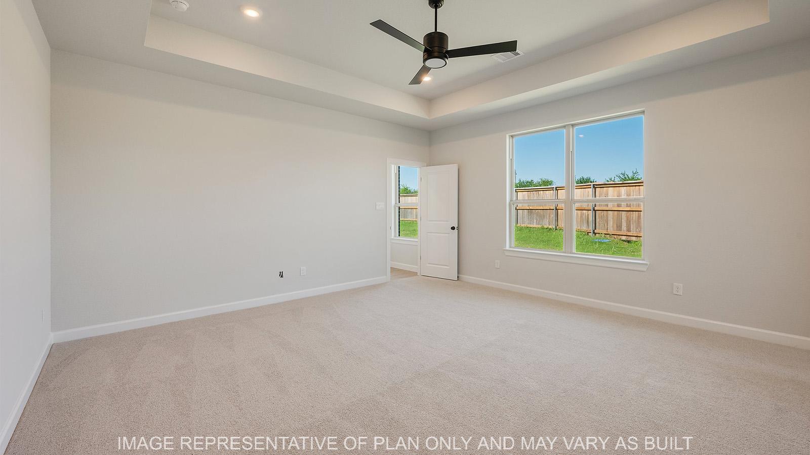 Weston primary bedroom with carpeted flooring, ceiling fan, and windows.