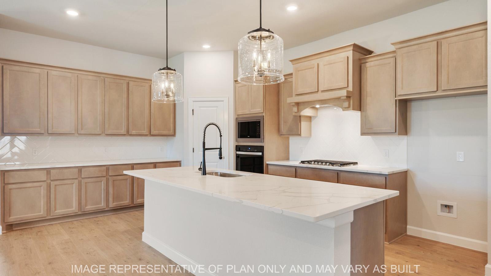 Weston kitchen with white marble quartz, custom maple cabinetry, and stainless-steel appliances.