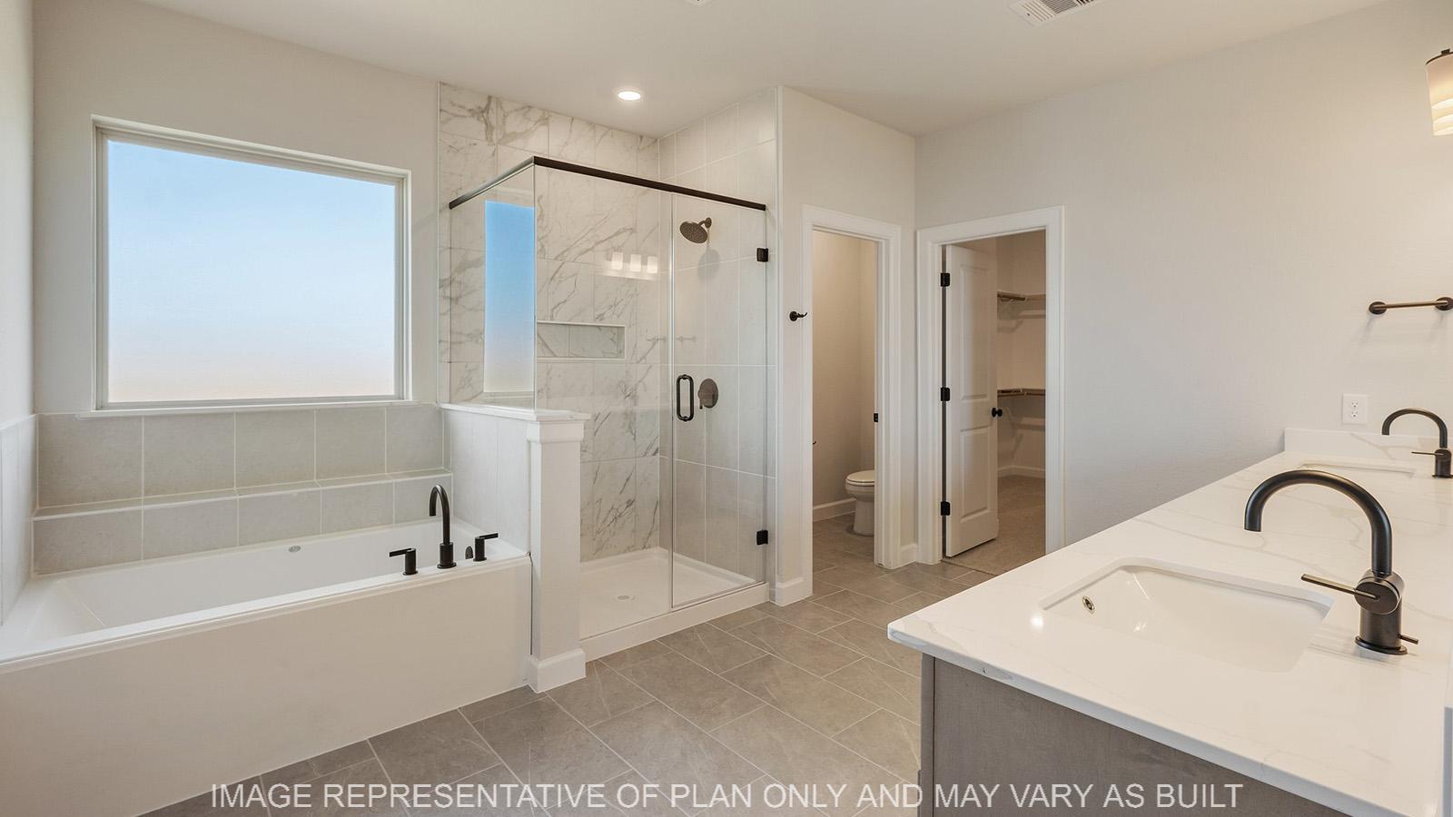 Weston primary bathroom with separate tub and shower, dual quartz vanity, and tile flooring.