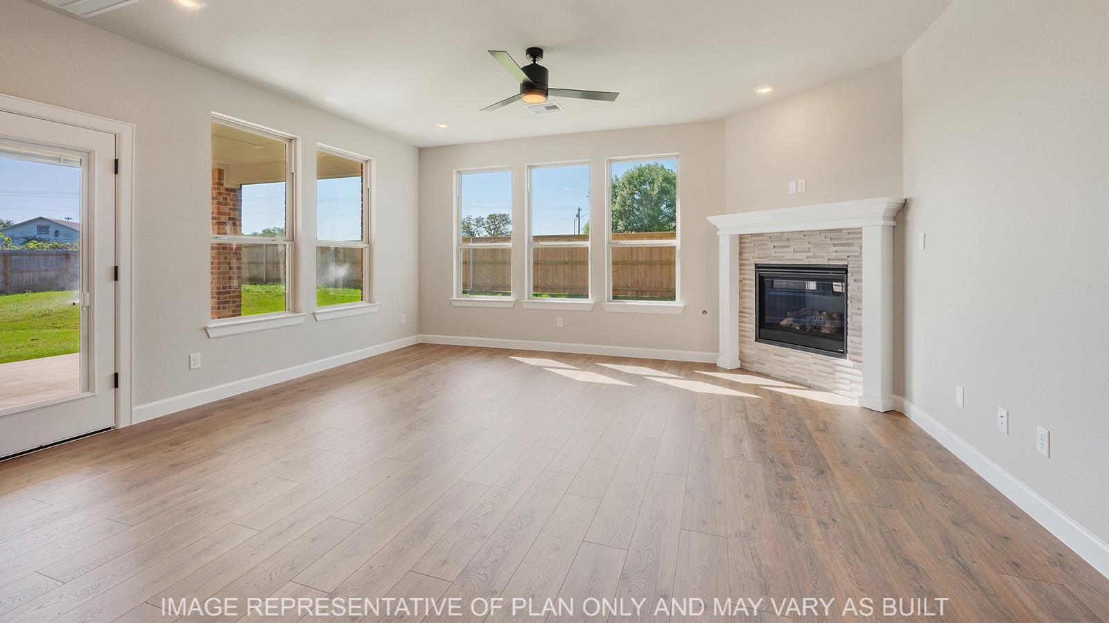 Norwood living room with corner fireplace, ceiling fan, and back door.